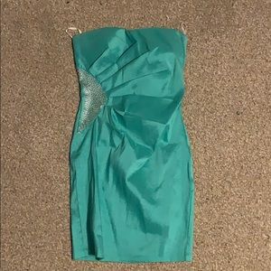 Light blue/green colored dress.